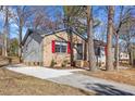 This lovely single-story home features mixed siding, updated windows, and a large concrete driveway at 2400 Keith Dr, Raleigh, NC 27610