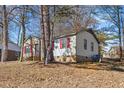 Side view of the house showcasing red shutters and landscaping at 2400 Keith Dr, Raleigh, NC 27610