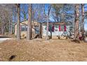 Front view of a charming brick ranch house with red shutters and a well-maintained lawn at 2400 Keith Dr, Raleigh, NC 27610