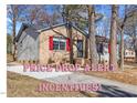 Charming single-story home with mature trees, brick accents, red shutters and a paved driveway at 2400 Keith Dr, Raleigh, NC 27610