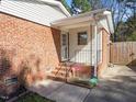 Brick back entrance featuring a small covered porch and secure access to the home's interior at 2509 Foxgate Dr, Raleigh, NC 27610
