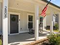 Front porch with rocking chairs and American flag at 2808 Raddercrest Ct, Fuquay Varina, NC 27526