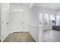 Bright foyer featuring tile floors, coat closet, and an open view to the living area at 307 Walnut Woods Dr, Morrisville, NC 27560