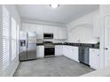 Updated kitchen featuring white cabinets, granite countertops, and stainless steel appliances at 307 Walnut Woods Dr, Morrisville, NC 27560