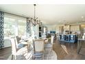 Open concept dining area with round table and seating for six at 3142 Armeria Dr, Apex, NC 27502