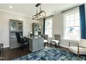 Spacious home office with built-in shelving and large windows at 3142 Armeria Dr, Apex, NC 27502