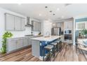 Modern kitchen featuring gray cabinets, quartz countertops, and an island at 328 Golf Vista Trl, Holly Springs, NC 27540