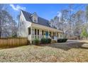 House with a light green exterior, white trim, and a landscaped front yard at 3425 Old Graham Rd, Pittsboro, NC 27312