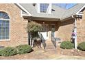 Front entrance with brick accents and landscaping at 414 Bakewell Ct, Wake Forest, NC 27587