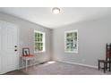Spacious living room with two windows and neutral decor at 423 Potter St, Durham, NC 27701