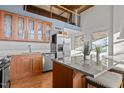 Modern kitchen with wood cabinets, granite counters, and island at 500 N Duke St # 56-207, Durham, NC 27701
