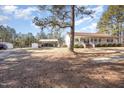 Residential home with a large yard, a carport, and additional storage structures at 5141 Nc-39 N Hwy, Henderson, NC 27537