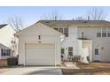 A spacious backyard featuring a private patio with outdoor furniture, an attached garage, and serene landscaping at 5809 Neuse Wood Dr, Raleigh, NC 27616