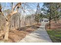 Driveway approaching home showcasing a wooded setting at 5920 Orchid Valley Rd, Raleigh, NC 27613