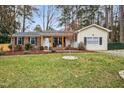 Charming single-Gathering home boasts a well-maintained lawn, mature trees, and inviting curb appeal at 5920 Whittier Dr, Raleigh, NC 27609