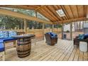 Relaxing screened in porch featuring wood floors and a unique fire pit table, great for entertaining at 5920 Whittier Dr, Raleigh, NC 27609