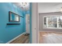 Entryway with mirror, coat rack, and view into living room at 69 Forest Oaks Dr, Durham, NC 27705