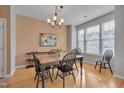Dining room with wood table, four chairs, and hardwood floors at 7860 Silverthread Ln, Raleigh, NC 27617