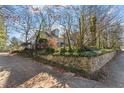 Side view of the house, showcasing stone wall and landscaping at 806 E Franklin St, Chapel Hill, NC 27514