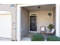 Inviting covered porch with wicker chairs, perfect for relaxing at 8252 Primanti Blvd, Raleigh, NC 27612