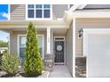 Inviting front entrance with decorative door, stone accents, and well-maintained landscaping at 130 Daniel Farm Dr, Benson, NC 27504