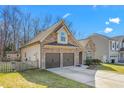 Rear view of a charming house with stone and siding accents, two-car garage at 2242 Colorado Dr, Graham, NC 27253