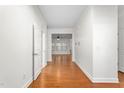Bright hallway with hardwood floors leading to living areas at 2242 Colorado Dr, Graham, NC 27253