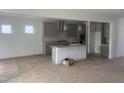 A bright open-concept kitchen with an island, gray cabinets, and stainless steel appliances at 250 Tidal Pool Way, Cary, NC 27519