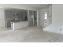 Spacious, unfinished kitchen featuring gray cabinets, an island, and view into the living area at 250 Tidal Pool Way, Cary, NC 27519