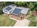 Aerial view of the home with solar panels, driveway, and landscaping at 326 W Bywood Dr, Durham, NC 27712