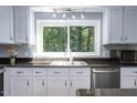 Renovated kitchen featuring white cabinets, stainless steel appliances, and natural light at 326 W Bywood Dr, Durham, NC 27712