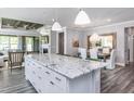 Modern kitchen with white cabinets, granite countertops, and an island at 334 Arcadius Dr, Clayton, NC 27520