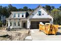 New two-story home being built with siding, visible garage, and under construction landscape at 387 E Clydes Point Way, Wendell, NC 27591