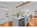 Renovated kitchen with white cabinets, quartz countertops, and an eat-in island at 420 Nelson St, Durham, NC 27707