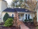 House exterior showcasing a brick walkway and well-maintained landscaping at 446 Crossvine Close, Pittsboro, NC 27312
