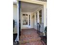 Front entry with brick steps, a white door and black railings at 446 Crossvine Close, Pittsboro, NC 27312