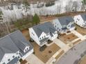 White houses in a waterfront community, showcasing neighborhood and lake views at 547 Glenville Lake Dr, Fuquay Varina, NC 27526