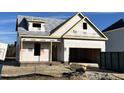 New home under construction featuring brick foundation, framed windows, and attached two-car garage at 59 Pretty Run Branch Ln, Wendell, NC 27591
