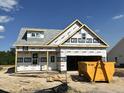 New construction home showing the initial phase, complete with installed windows and wrapped with home guard at 59 Pretty Run Branch Ln, Wendell, NC 27591