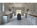 Unfinished kitchen with white cabinets, a center island, and sliding glass doors at 59 Pretty Run Branch Ln, Wendell, NC 27591