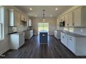 Bright kitchen with gray cabinets, granite countertops, subway tile backsplash, and stainless steel microwave at 59 Pretty Run Branch Ln, Wendell, NC 27591