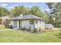 Updated white brick ranch house with new deck at 713 Hudson Ave, Durham, NC 27704