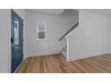 Bright entryway featuring wood floors, a staircase, and a blue front door with glass panels at 930 Allen Pk Dr, Raleigh, NC 27604
