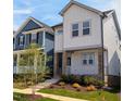 Stylish two-story home with white siding, a cozy front porch, and beautifully landscaped front yard at 930 Allen Pk Dr, Raleigh, NC 27604