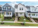 Street view of a modern two-story home featuring neat landscaping, sidewalks, and neighboring houses at 930 Allen Pk Dr, Raleigh, NC 27604