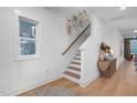 Bright hallway features hardwood floors, stylish staircase, and modern decor accents at 930 Allen Pk Dr, Raleigh, NC 27604