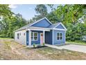 Side view of blue home with white trim and a pink front door, showcasing its curb appeal at 0 Cedar Grove Church Rd Rd, Roxboro, NC 27574