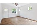 Living room with laminate floors, white walls and trim, and a door to the outside at 0 Cedar Grove Church Rd Rd, Roxboro, NC 27574