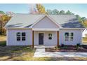 Newly constructed light gray house with a dark blue front door and wood-toned columns at 0 Theresia Ln, Roxboro, NC 27574