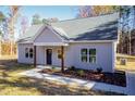 Newly constructed light gray house with a dark blue front door and wood-toned columns at 0 Theresia Ln, Roxboro, NC 27574